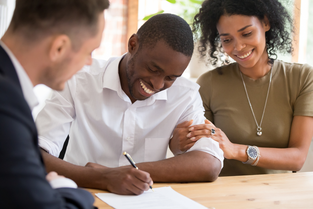 Young Couple Signing a Mortgage Agreement